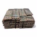 Stacked CuMn30 Copper Manganese master alloy waffle plates for industrial deoxidation and alloying, bundled for delivery.