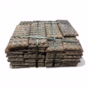 Stacked CuMn30 Copper Manganese master alloy waffle plates for industrial deoxidation and alloying, bundled for delivery.