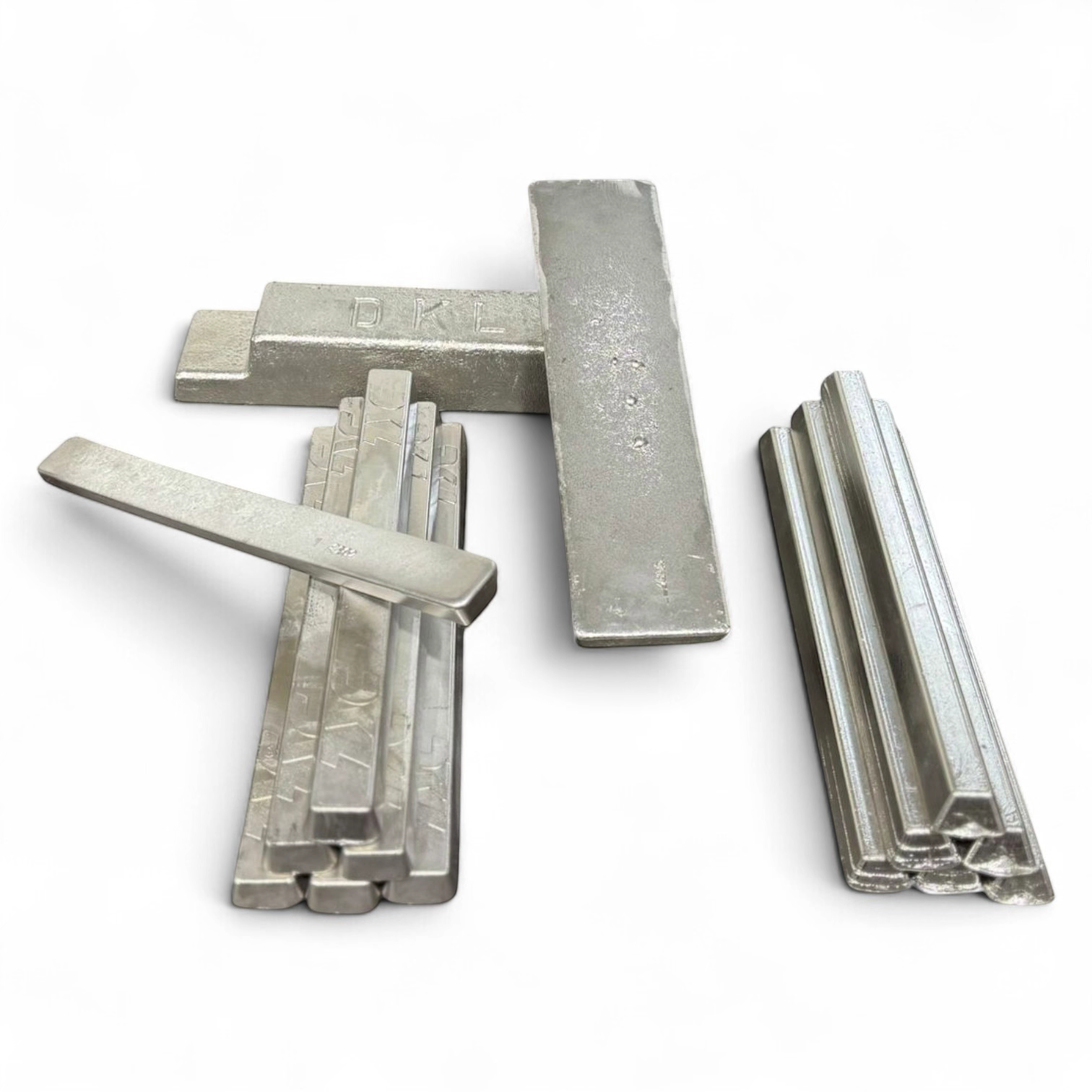 An array of DKL Metals custom fusible alloy form factors, including stacked 7-8kg ingots, a DKL branded 1kg bar layout, and plain 1kg fusible metal bars set against a clean studio background.