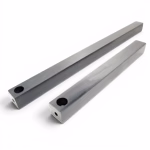Two long, square-shaped lead window weights are positioned diagonally against a white background. Each metallic weight features a large circular hole near one end and a smaller hole centered on the adjacent tip, used for securing the sash cord.