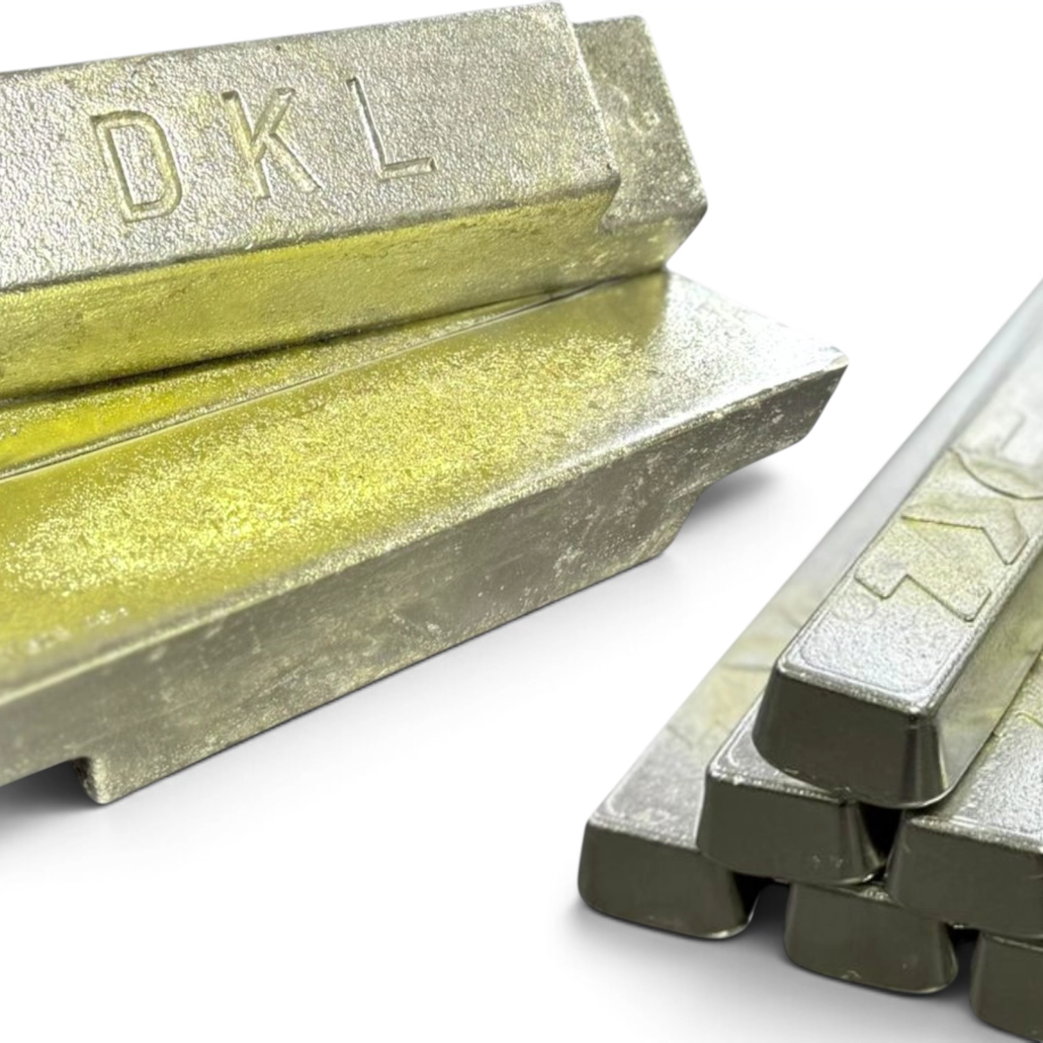 DKL Metals custom Babbitt white metal bearing alloy ingots stacked beside a bundle of 1kg industrial solder bars.